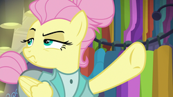 Size: 1280x720 | Tagged: safe, screencap, fluttershy, pegasus, pony, fake it 'til you make it, g4, alter ego, alternate hairstyle, clothes, female, folded wings, hair bun, lidded eyes, manehattan, mare, pointing, raised eyebrow, raised hoof, rarity for you, severeshy, solo, tail bun, underhoof, wings
