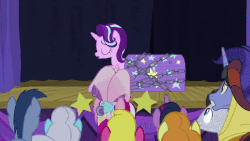 Size: 800x450 | Tagged: safe, screencap, blues, bon bon, caramel, carrot top, daisy, flower wishes, golden harvest, goldengrape, granny smith, hoo'far, noteworthy, princess cadance, princess flurry heart, royal riff, sir colton vines iii, starlight glimmer, sweetie drops, trixie, twilight sparkle, alicorn, earth pony, pony, saddle arabian, unicorn, road to friendship, animated, baby, baby pony, cape, chains, cheering, chest, clothes, crowd, female, hat, magic show, magic trick, male, mare, stage, stallion, trixie's cape, trixie's hat, twilight sparkle (alicorn)
