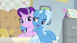 Size: 1280x720 | Tagged: safe, screencap, starlight glimmer, trixie, pony, unicorn, g4, road to friendship, belly, bipedal, bipedal leaning, desk, duo, duo female, female, hug, leaning, mare, raised eyebrow, starlight's office