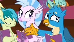 Size: 1066x600 | Tagged: safe, screencap, gallus, sandbar, silverstream, earth pony, griffon, hippogriff, pony, g4, the end in friend, boomerang (tv channel), confused, eyes closed, female, male, notebook, notepad, pencil, teenager, trio, youtube link