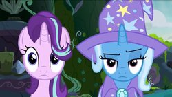 Size: 1136x640 | Tagged: safe, screencap, starlight glimmer, trixie, pony, unicorn, g4, to change a changeling, cape, clothes, hair flip, hair over one eye, hat, raised eyebrow, trixie is not amused, trixie's cape, trixie's hat, unamused