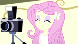 Size: 1280x720 | Tagged: safe, screencap, fluttershy, equestria girls, g4, my little pony equestria girls: summertime shorts, pet project, ^^, camera, clothes, cute, eyes closed, eyeshadow, female, hairpin, makeup, pink hair, shyabetes, sleeveless, smiling, solo, tank top, yellow skin