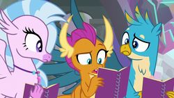 Size: 1280x720 | Tagged: safe, screencap, gallus, silverstream, smolder, dragon, griffon, hippogriff, g4, the end in friend, dragoness, female, jewelry, male, necklace, notebook, raised eyebrow, reading, trio