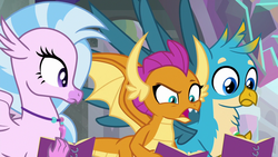 Size: 1280x720 | Tagged: safe, screencap, gallus, silverstream, smolder, dragon, griffon, hippogriff, g4, the end in friend, dragoness, female, jewelry, male, necklace, notebook, open mouth, raised eyebrow, spread wings, wings