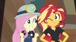 Size: 1280x720 | Tagged: safe, screencap, fluttershy, sunset shimmer, equestria girls, g4, my little pony equestria girls: better together, opening night, opening night: sunset shimmer, female, miner, one eye closed, wink