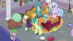Size: 1920x1080 | Tagged: safe, screencap, gallus, ocellus, sandbar, silverstream, smolder, spike, yona, changedling, changeling, classical hippogriff, dragon, earth pony, griffon, hippogriff, pony, yak, g4, the hearth's warming club, bow, butt, cloven hooves, couch, dragoness, female, hair bow, jewelry, male, monkey swings, necklace, plot, present, student six, teenager, winged spike, wings