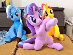 Size: 1024x768 | Tagged: safe, artist:nekokevin, starlight glimmer, sunset shimmer, trixie, pony, unicorn, series:nekokevin's glimmy, g4, female, irl, looking at you, magical trio, mare, photo, plushie, pose, raised hoof, sitting, smiling, underhoof