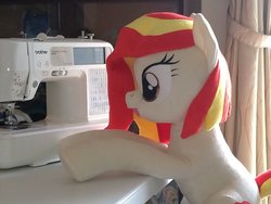 Size: 1200x900 | Tagged: safe, artist:nekokevin, oc, oc:poniko, earth pony, pony, female, irl, mare, open mouth, photo, plushie, raised hoof, sewing machine, smiling, solo, table