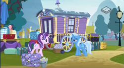Size: 574x315 | Tagged: safe, screencap, starlight glimmer, trixie, pony, unicorn, g4, road to friendship, boomerang (tv channel), caravan, chains, chest, duo, female, lamppost, luggage, mare, outdoors, stage, trixie's wagon