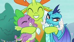 Size: 1280x720 | Tagged: safe, princess ember, spike, thorax, changedling, changeling, dragon, g4, triple threat, annoyed, aside glance, changeling king, dragon lord ember, dragoness, eyeroll, eyes closed, female, forgiveness, group hug, happy, hug, king thorax, male, raised eyebrow, smiling, trio, uncomfortable