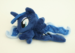 Size: 1000x716 | Tagged: safe, artist:yukamina-plushies, princess luna, alicorn, pony, g4, beanie (plushie), female, horn, irl, mare, missing accessory, photo, plushie, prone, solo, spread wings, wings