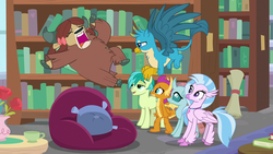 Size: 1280x720 | Tagged: safe, screencap, gallus, ocellus, sandbar, silverstream, smolder, yona, changedling, changeling, classical hippogriff, dragon, earth pony, griffon, hippogriff, pony, yak, g4, what lies beneath, beanbag chair, book, bookshelf, bow, cloven hooves, dragoness, female, hair bow, jewelry, library, male, monkey swings, necklace, student six, teenager