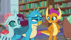 Size: 1280x720 | Tagged: safe, screencap, gallus, ocellus, smolder, yona, changedling, changeling, dragon, griffon, g4, what lies beneath, bookshelf, dragoness, female, male, trio