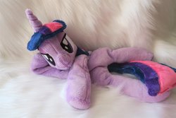 Size: 1024x683 | Tagged: safe, artist:kazzysart, twilight sparkle, alicorn, pony, g4, beanie (plushie), female, folded wings, horn, irl, lidded eyes, looking at you, mare, on side, photo, plushie, solo, twilight sparkle (alicorn), wings