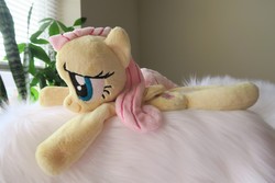 Size: 5472x3648 | Tagged: safe, artist:kazzysart, fluttershy, pegasus, pony, g4, beanie (plushie), female, folded wings, irl, mare, photo, plushie, prone, solo, wings