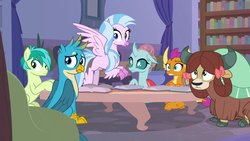 Size: 1280x720 | Tagged: safe, screencap, gallus, ocellus, sandbar, silverstream, smolder, yona, changedling, changeling, classical hippogriff, dragon, earth pony, griffon, hippogriff, pony, yak, g4, what lies beneath, bow, cloven hooves, dragoness, female, hair bow, jewelry, male, monkey swings, necklace, sitting, student six, teenager