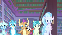Size: 1280x720 | Tagged: safe, screencap, gallus, ocellus, sandbar, silverstream, smolder, yona, changedling, changeling, dragon, earth pony, griffon, hippogriff, pony, yak, g4, what lies beneath, confused, dragoness, female, glowing, jewelry, library, male, necklace, raised eyebrow, student six, teenager