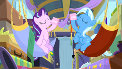 Size: 1600x900 | Tagged: safe, screencap, starlight glimmer, trixie, pony, unicorn, g4, my little pony best gift ever, cup, drinking, duo, eyes closed, female, hammock, hoof hold, mare, teacup, trixie's wagon