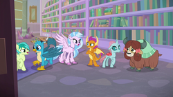 Size: 1280x720 | Tagged: safe, screencap, gallus, ocellus, sandbar, silverstream, smolder, yona, changedling, changeling, classical hippogriff, dragon, earth pony, griffon, hippogriff, pony, yak, g4, what lies beneath, bow, cloven hooves, crossed arms, dragoness, female, hair bow, happy, jewelry, library, male, monkey swings, necklace, school of friendship, student six, teenager