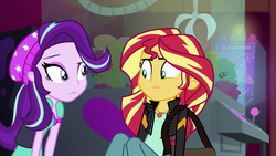 Size: 1920x1080 | Tagged: safe, screencap, starlight glimmer, sunset shimmer, equestria girls, equestria girls specials, g4, my little pony equestria girls: mirror magic, beanie, claw machine, female, hat, looking at each other, messenger bag