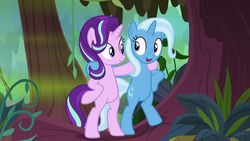 Size: 1280x720 | Tagged: safe, screencap, starlight glimmer, trixie, pony, unicorn, g4, road to friendship, belly, bipedal, duo, female, hoof around neck, hooves on hips, looking at each other, mare, open mouth, smiling, standing, swamp, tree, we're friendship bound