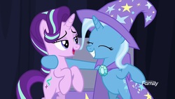 Size: 1600x900 | Tagged: safe, screencap, starlight glimmer, trixie, pony, unicorn, g4, road to friendship, cape, clothes, duo, eyes closed, female, hat, lidded eyes, mare, rearing, smiling, trixie's cape, trixie's hat, wizard hat