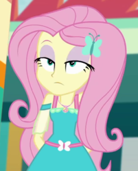 Size: 579x720 | Tagged: safe, screencap, fluttershy, equestria girls, equestria girls specials, g4, my little pony equestria girls: better together, my little pony equestria girls: rollercoaster of friendship, arm behind back, clothes, cropped, dress, female, fluttershy is not amused, geode of fauna, hairpin, solo, teenager, unamused
