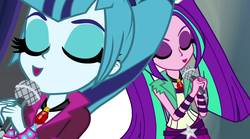 Size: 1280x714 | Tagged: safe, screencap, aria blaze, sonata dusk, equestria girls, g4, my little pony equestria girls: rainbow rocks, duo, duo female, eyes closed, female, gem, microphone, pigtails, ponytail, singing, siren gem, twintails