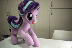 Size: 600x399 | Tagged: safe, artist:nekokevin, starlight glimmer, pony, unicorn, series:nekokevin's glimmy, g4, animated, chair, clapping, cute, excited, female, gif, glimmerbetes, happy, hoofy-kicks, irl, looking at you, lying down, mare, open mouth, photo, plushie, raised hoof, silly, silly pony, sitting, smiling, solo, starlight says bravo, stop motion, table, underhoof, weapons-grade cute