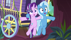 Size: 1920x1080 | Tagged: safe, screencap, starlight glimmer, trixie, pony, g4, road to friendship, carriage, female, mare, open mouth, pushing, surprised, trixie's wagon, wagon, we're friendship bound