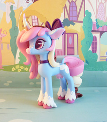 Size: 749x850 | Tagged: safe, artist:krowzivitch, oc, oc only, oc:polly, cow, cow pony, pony, unicorn, bow, choker, cloven hooves, craft, curved horn, diorama, female, figurine, hair bow, heart eyes, horn, mare, sculpture, solo, standing, traditional art, udder, unshorn fetlocks, wingding eyes