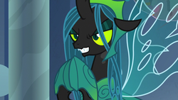 Size: 1280x720 | Tagged: safe, screencap, queen chrysalis, changeling, changeling queen, g4, the ending of the end, armor, crown, evil, evil grin, eyeshadow, female, former queen chrysalis, grin, hoof shoes, hooves together, jewelry, makeup, narrowed eyes, regalia, slit pupils, smiling, solo, spread wings, ultimate chrysalis, wings