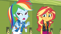 Size: 1600x900 | Tagged: safe, screencap, rainbow dash, sunset shimmer, equestria girls, equestria girls specials, g4, my little pony equestria girls: better together, my little pony equestria girls: holidays unwrapped, clothes, female, geode of empathy, geode of super speed, jacket, lockers, magical geodes, unamused, wristband