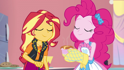 Size: 1920x1080 | Tagged: safe, screencap, pinkie pie, sunset shimmer, equestria girls, equestria girls specials, g4, my little pony equestria girls: better together, my little pony equestria girls: holidays unwrapped, saving pinkie's pie, apron, clothes, cookie, cute, diapinkes, duo, duo female, eyes closed, female, food, geode of empathy, jacket, jewelry, leather, leather jacket, magical geodes, necklace, oven mitts, ramekin, shimmerbetes, smiling, sniffing, souffle, tank top