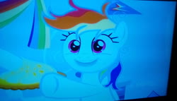Size: 1600x912 | Tagged: safe, screencap, rainbow dash, pegasus, pony, g4, season 7, secrets and pies, angle, discovery family logo, food, hoof hold, messy mane, photo, pie, rainbow dash's bedroom, smiling, television, woken up at a bad time