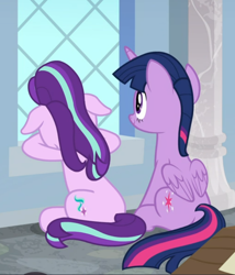 Size: 658x769 | Tagged: safe, screencap, starlight glimmer, twilight sparkle, alicorn, pony, unicorn, a horse shoe-in, g4, cropped, duo, female, floppy ears, mare, rear view, sitting, smiling, twilight sparkle (alicorn)