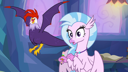 Size: 1920x1080 | Tagged: safe, screencap, edith, silverstream, classical hippogriff, cockatrice, hippogriff, g4, student counsel, duo, female, open beak, pencil, red eyes, spread wings, treehouse of harmony, wings