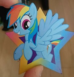 Size: 1080x1113 | Tagged: safe, artist:omegapony16, rainbow dash, pegasus, pony, g4, coaster, female, grin, hand, irl, mare, offscreen character, photo, pov, rearing, smiling
