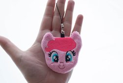 Size: 1000x674 | Tagged: safe, artist:meplushyou, pinkie pie, earth pony, human, pony, g4, charm, female, hand, irl, irl human, looking at you, mare, photo, plushie, smiling