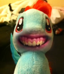Size: 1080x1245 | Tagged: safe, editor:kw studio, rainbow dash, pegasus, pony, g4, bedroom, creepy, creepy smile, cursed image, disturbing, explicit source, female, horrifying, human mouth, irl, mare, nightmare fuel, photo, plushie, pony thread simulator, realistic mouth, shitposting, smiling, stuffed with pleasure: lick it..., synchro-vox, terrifying, wat, what has science done, wtf, youtube screencap