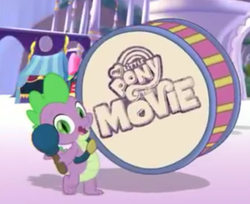 Size: 661x540 | Tagged: safe, screencap, spike, dragon, g4, my little pony: the movie, cropped, drums, male, musical instrument, my little pony: the movie logo, smiling