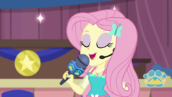 Size: 1280x720 | Tagged: safe, screencap, fluttershy, best in show: the victory lap, equestria girls, g4, my little pony equestria girls: better together, eyes closed, eyeshadow, female, makeup, microphone, open mouth, smiling, solo