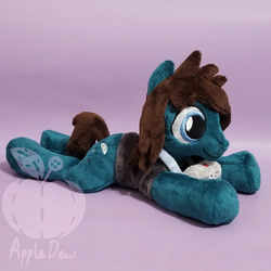 Size: 1248x1248 | Tagged: safe, artist:appledew, earth pony, pony, beanie (plushie), camera, clothes, commission, irl, male, photo, plushie, ponified, prone, shirt, smiling, solo, stallion, t-shirt, tom sykes, watermark