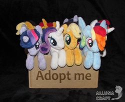 Size: 1714x1400 | Tagged: safe, artist:allunacraft, applejack, rainbow dash, rarity, sunset shimmer, twilight sparkle, pony, g4, adoption, applejack's hat, box, bronybait, cowboy hat, female, hat, horn, irl, mare, photo, plushie