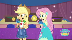 Size: 1920x1080 | Tagged: safe, screencap, applejack, fluttershy, best in show: the victory lap, equestria girls, g4, my little pony equestria girls: better together, applejack's hat, applejack's skirt, cowboy hat, female, geode of fauna, geode of super strength, hat, magical geodes, microphone