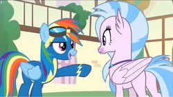 Size: 1261x710 | Tagged: safe, screencap, rainbow dash, silverstream, classical hippogriff, hippogriff, pegasus, pony, g4, uprooted, butt, clothes, duo, female, goggles, mare, plot, raised hoof, streambutt, uniform, wonderbolts uniform