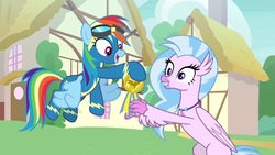 Size: 1920x1080 | Tagged: safe, screencap, rainbow dash, silverstream, classical hippogriff, hippogriff, pegasus, pony, g4, uprooted, clothes, duo, female, goggles, mare, medal, uniform, wonderbolts uniform