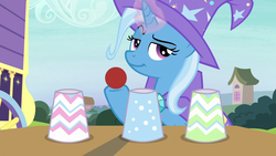 Size: 1280x720 | Tagged: safe, screencap, trixie, pony, g4, uncommon bond, ball, cup, female, glowing horn, hoof hold, horn, lidded eyes, magic trick, mare, smiling, smirk, solo