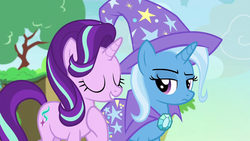 Size: 1280x720 | Tagged: safe, screencap, starlight glimmer, trixie, pony, unicorn, g4, to change a changeling, cape, changeling kingdom, clothes, eyes closed, female, frown, hat, mare, raised eyebrow, raised hoof, smiling, trixie is not amused, trixie's cape, trixie's hat, unamused