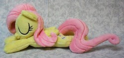 Size: 3158x1492 | Tagged: safe, artist:bluedragonflyplush, fluttershy, pegasus, pony, g4, beanie (plushie), eyes closed, folded wings, irl, photo, plushie, prone, sleeping, solo, wings